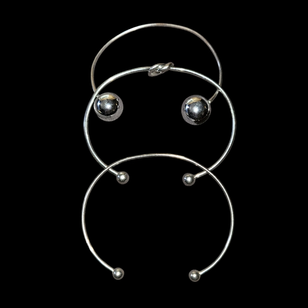 Bundle of three silver open style bangle bracelets